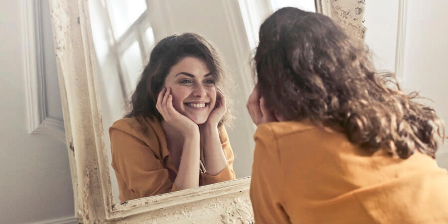 Happy Woman Looking in mirrow.