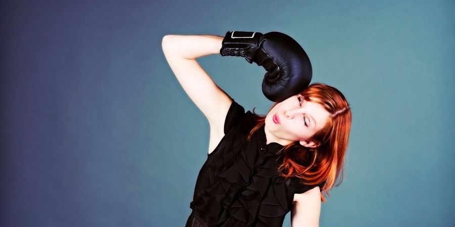 woman hitting herself with a boxing glove